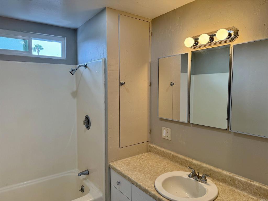 8762 Tyler Street, Unit A Spring Valley, CA 91977 - Photo 11 of 28 a bathroom with a granite countertop sink and a mirror