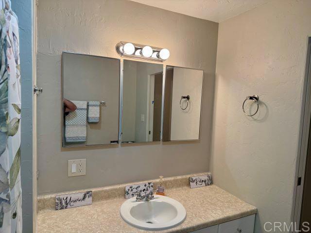 8762 Tyler Street, Unit A Spring Valley, CA 91977 - Photo 13 of 28 a bathroom with a sink and a mirror