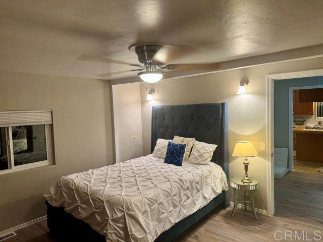 8762 Tyler Street, Unit A Spring Valley, CA 91977 - Photo 18 of 28 a bedroom with a bed and lamp on desk