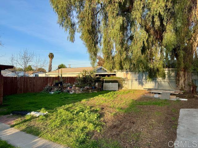 8762 Tyler Street, Unit A Spring Valley, CA 91977 - Photo 24 of 28 a view of a backyard with table and chairs plants and trees