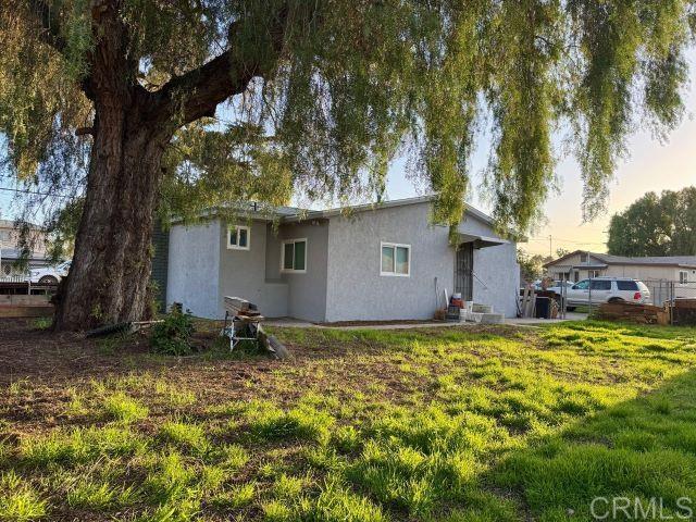 8762 Tyler Street, Unit A Spring Valley, CA 91977 - Photo 25 of 28 a backyard of a house with table and chairs