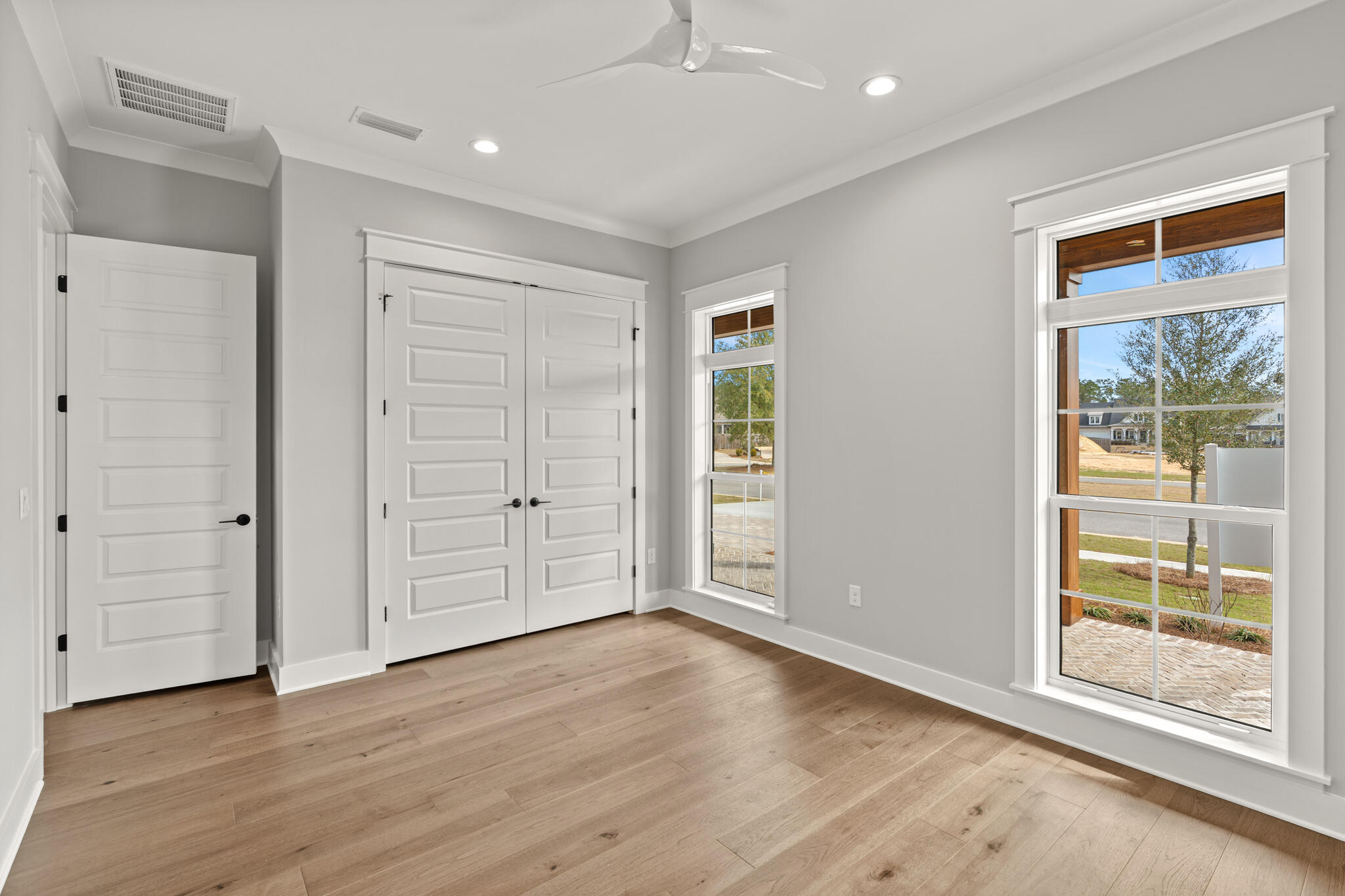 19 Caymus Cove Freeport, FL 32439 - Photo 29 of 41 an empty room with wooden floor cabinet and windows