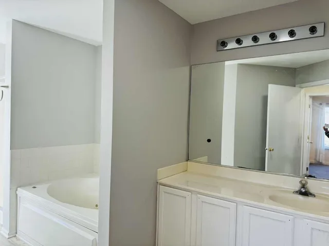 a bathroom with a bathtub and a sink