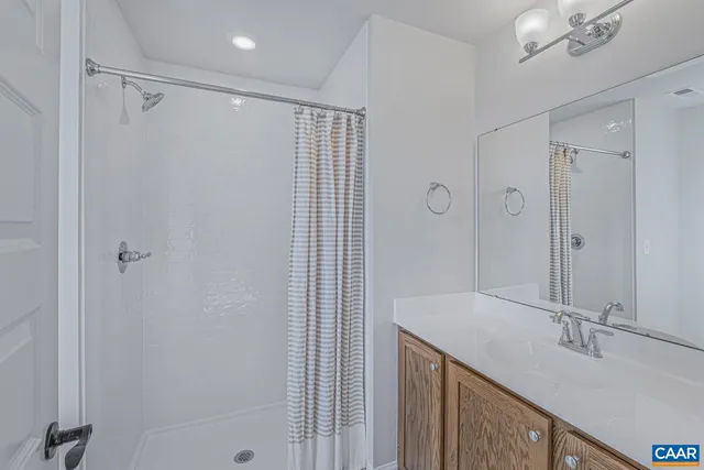 a bathroom with a shower and a sink