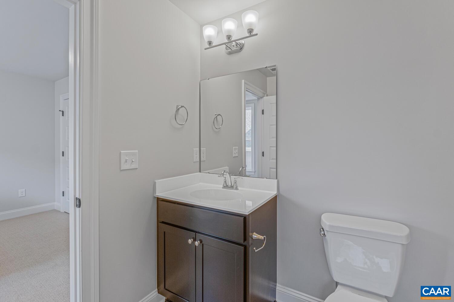 2 Agatha Ridge Lane, Unit LOT 2 Crozet, VA 22932 - Photo 31 of 42 a bathroom with a toilet sink and mirror