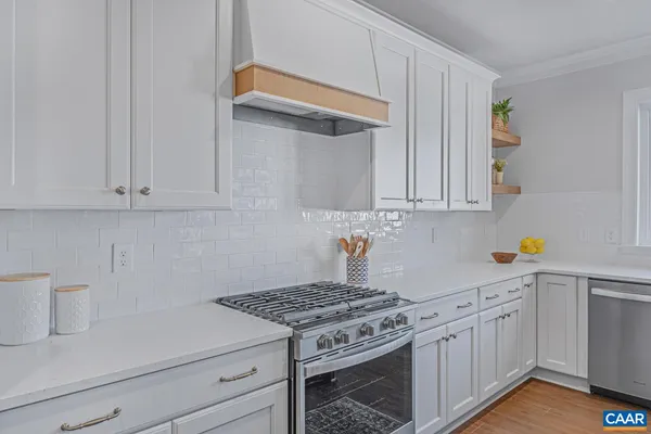 a kitchen with white cabinets and white appliances