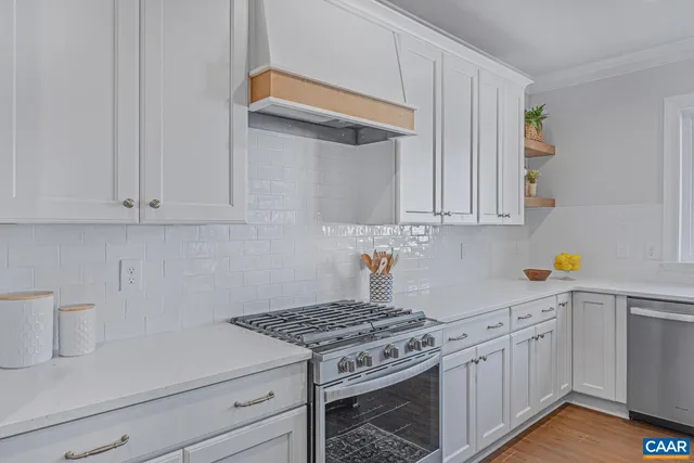 a kitchen with white cabinets and white appliances