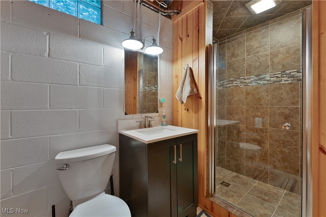 14 Clingan Road Struthers, OH 44471 - Photo 28 of 50 Full bathroom featuring a shower stall, vanity, and concrete block wall
