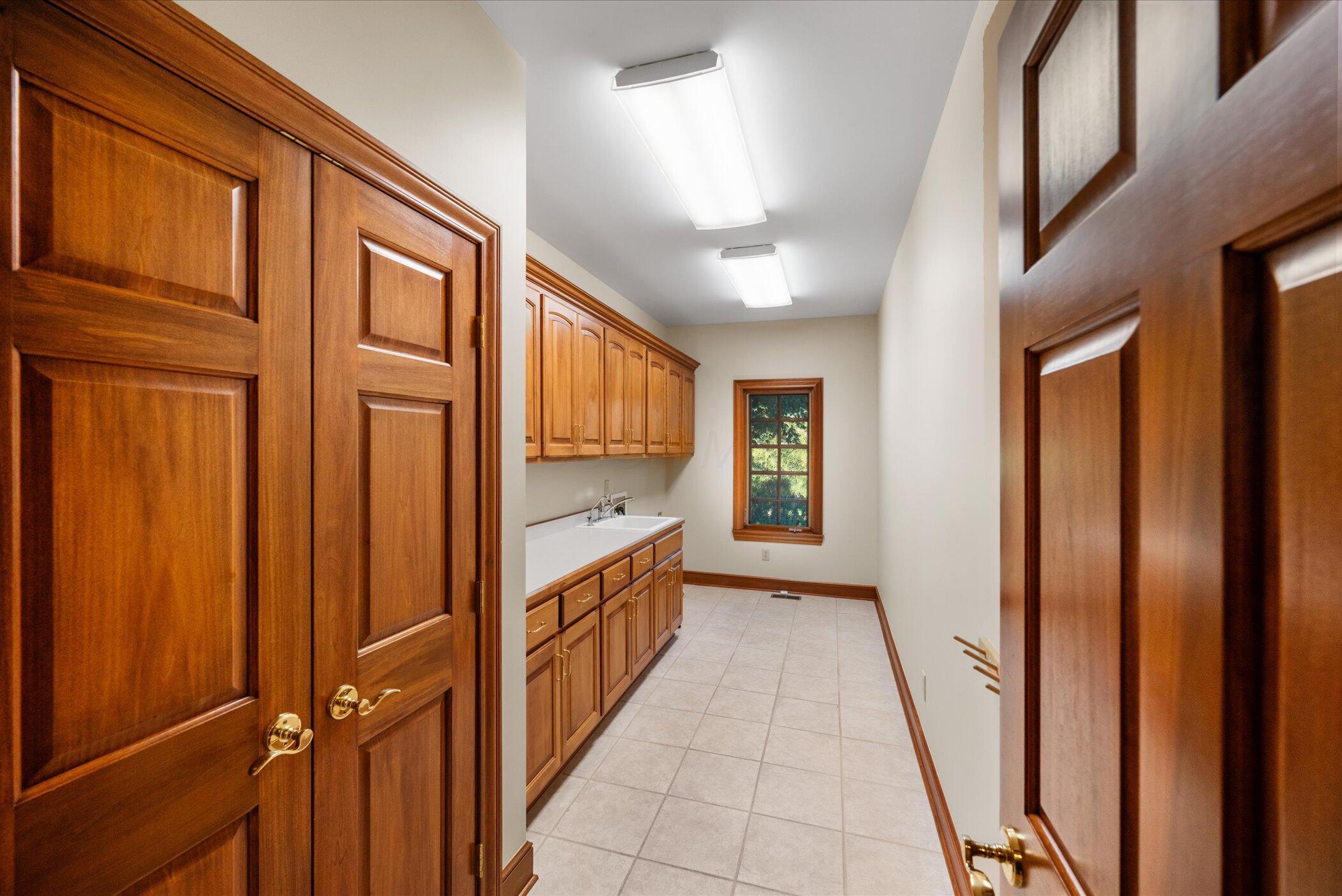 18261 Boerger Road Marysville, OH 43040 - Photo 32 of 94 Laundry room - WOW! Closet and cabinet storage - countertops and deep sink too!