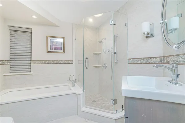 a bathroom with a bathtub and a shower