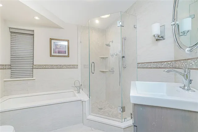 a bathroom with a bathtub and a shower