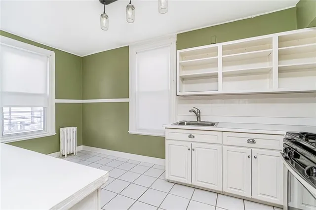 a kitchen with a sink cabinets and window