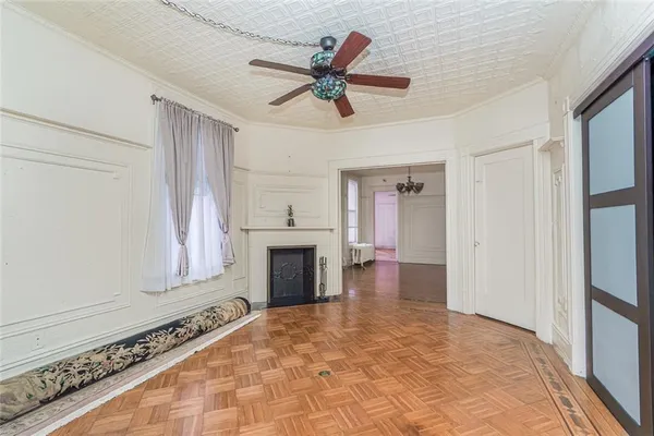 a view of an empty room with a fireplace and a window