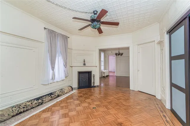 a view of an empty room with a fireplace and a window