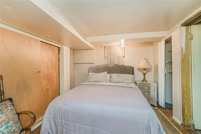 a bedroom with a bed and a mirror