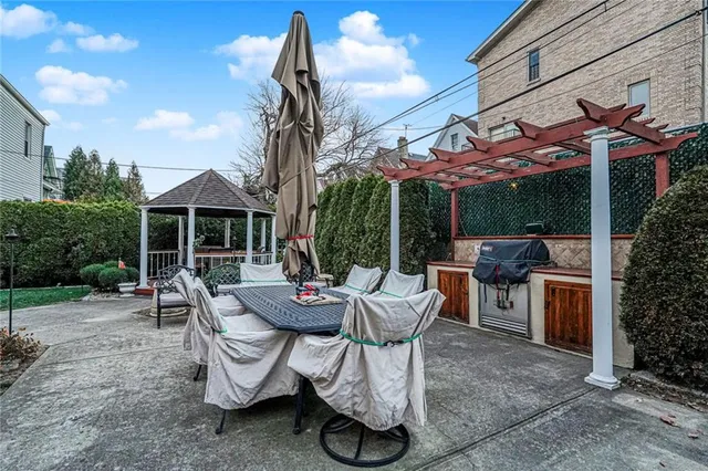 a view of a patio with table and chairs potted plants with wooden fence