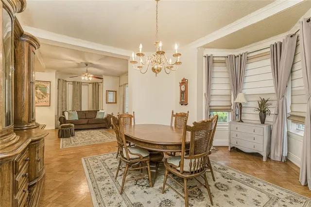 a view of a dining room with furniture and a chandelier