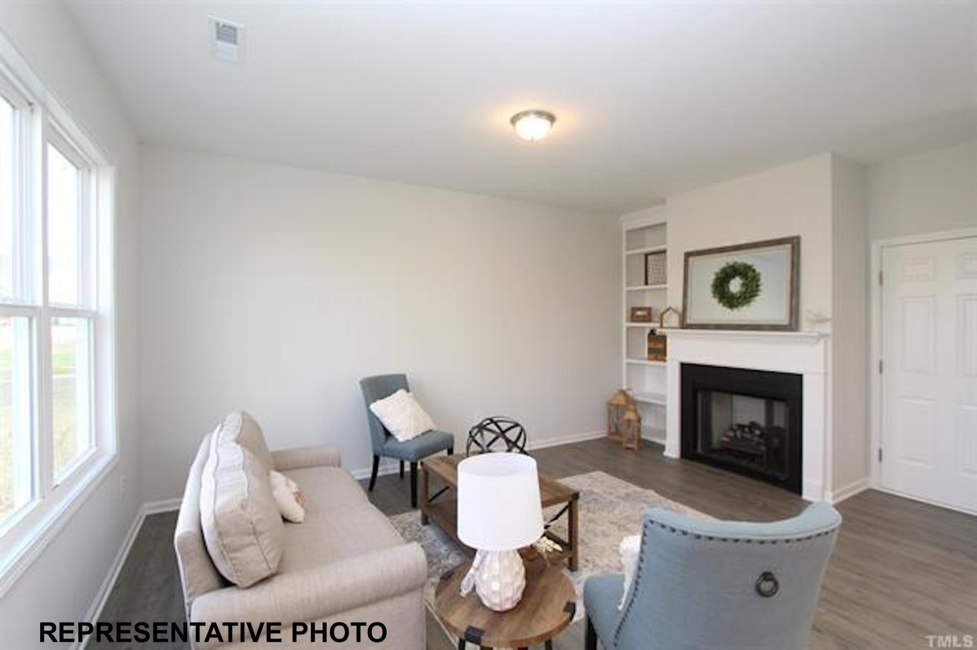 113 Springtooth Drive Zebulon, NC 27597 - Photo 6 of 13 a living room with furniture and a fireplace