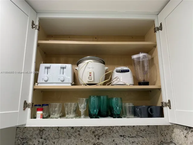 a view of shelf with clothes and shoes