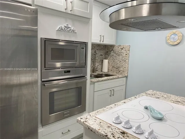 a kitchen with a appliances and cabinets