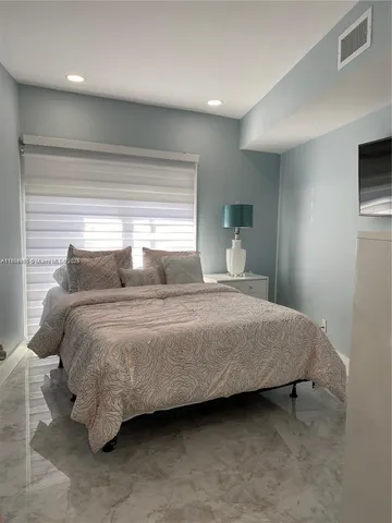 a bedroom with a bed and a tv