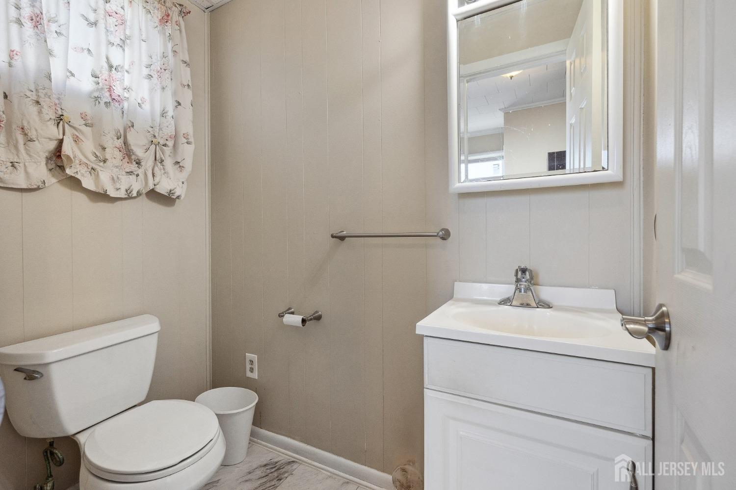 123 Madison Avenue Perth Amboy, NJ 08861 - Photo 13 of 30 a bathroom with a toilet sink and mirror