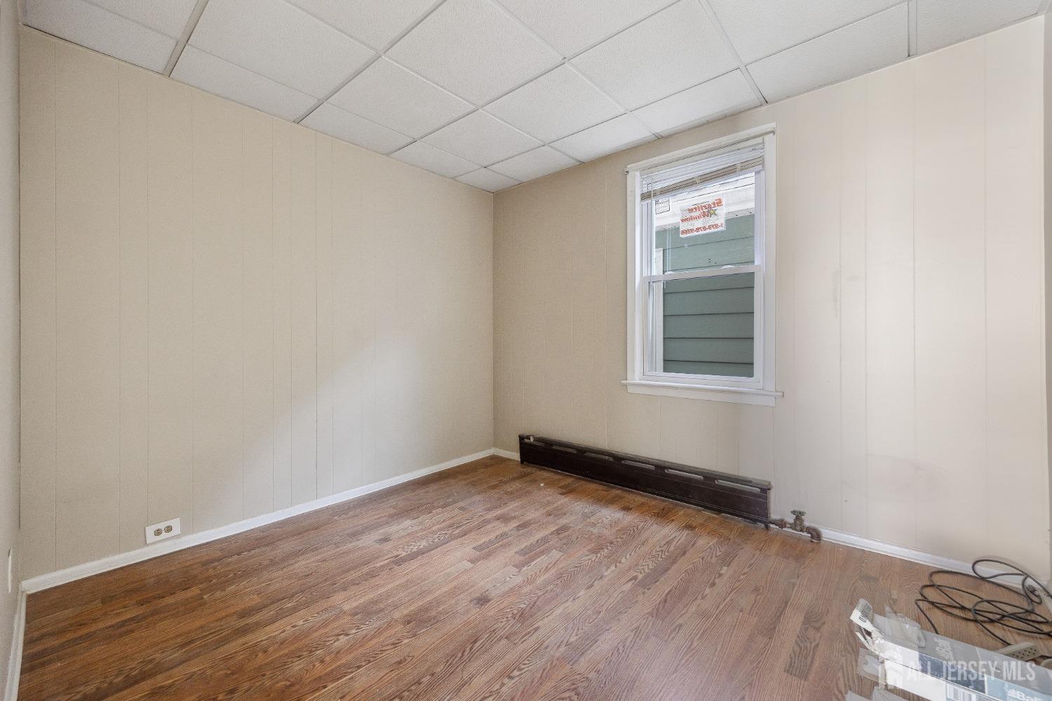 123 Madison Avenue Perth Amboy, NJ 08861 - Photo 15 of 30 a view of an empty room with wooden floor and a window