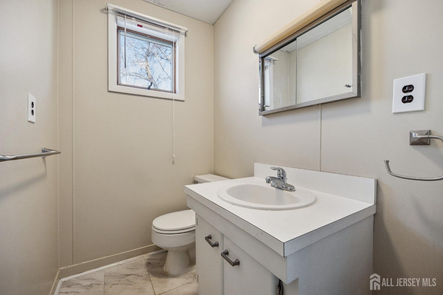 123 Madison Avenue Perth Amboy, NJ 08861 - Photo 18 of 30 a bathroom with a toilet sink and mirror