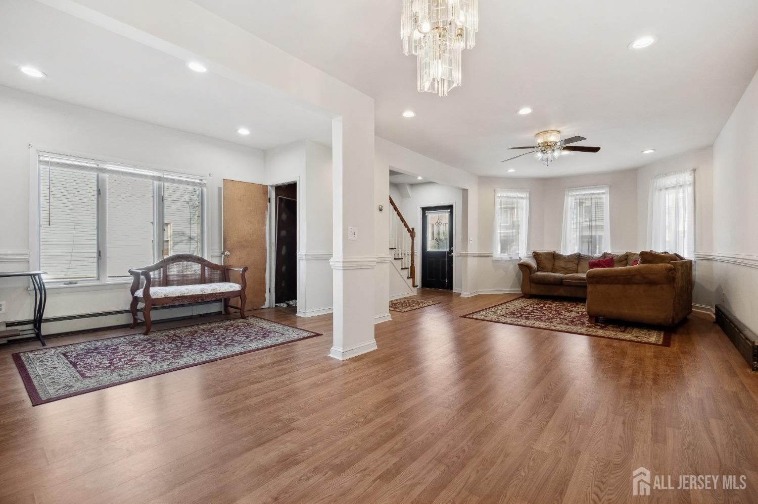 123 Madison Avenue Perth Amboy, NJ 08861 - Photo 7 of 30 a living room with furniture and a chandelier