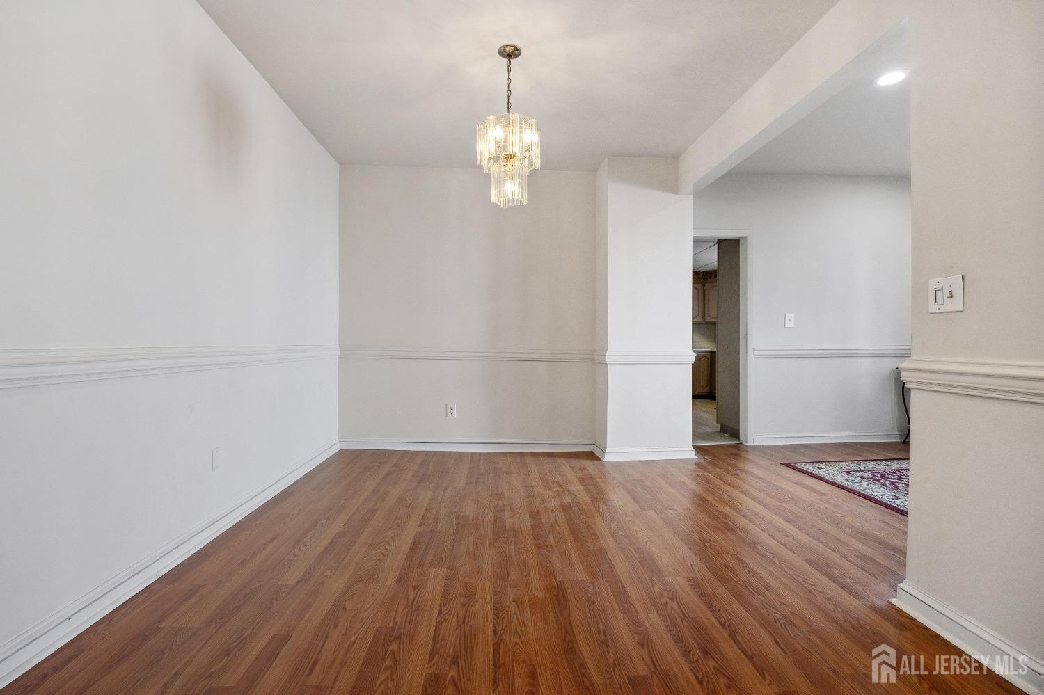 123 Madison Avenue Perth Amboy, NJ 08861 - Photo 8 of 30 a view of empty room with wooden floor and window