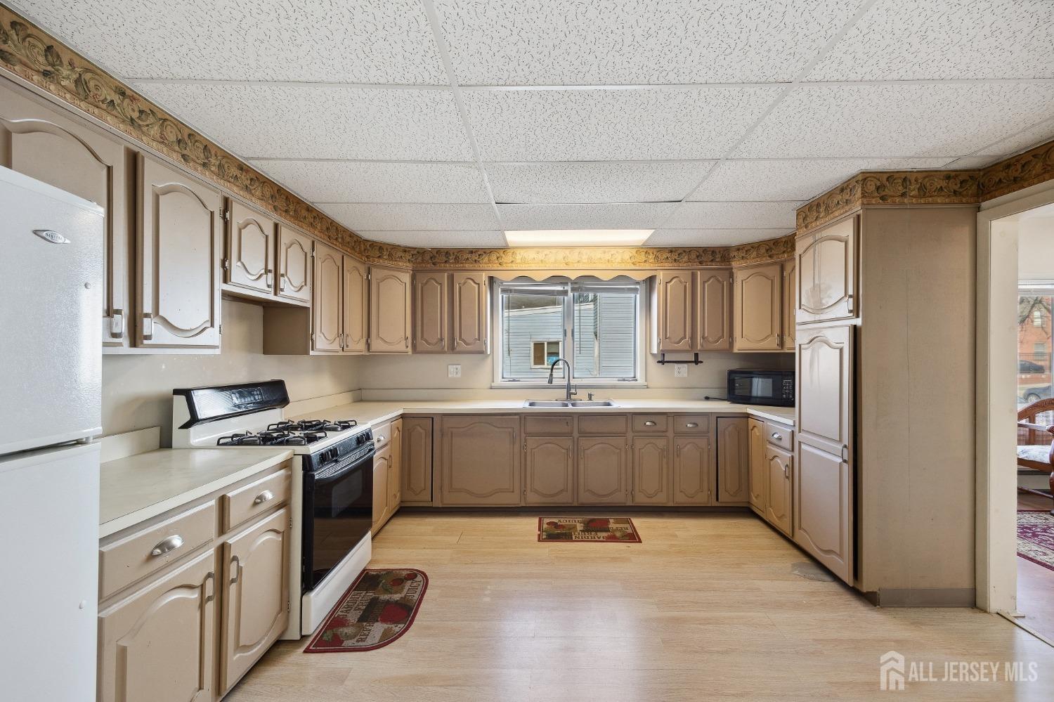 123 Madison Avenue Perth Amboy, NJ 08861 - Photo 9 of 30 a kitchen with a sink stainless steel appliances and cabinets