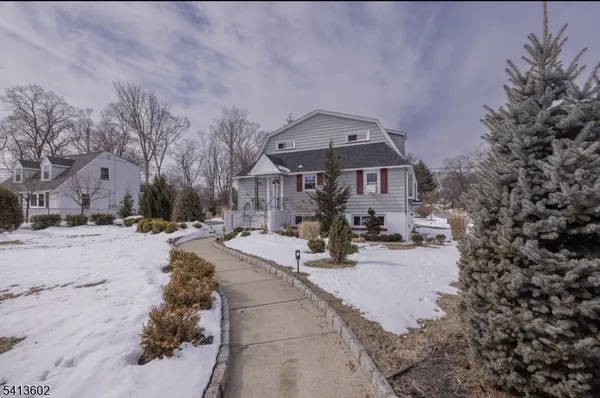 a view of a house with snow on the road