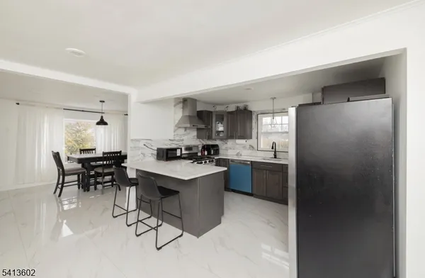 a kitchen with kitchen island a sink stove and refrigerator