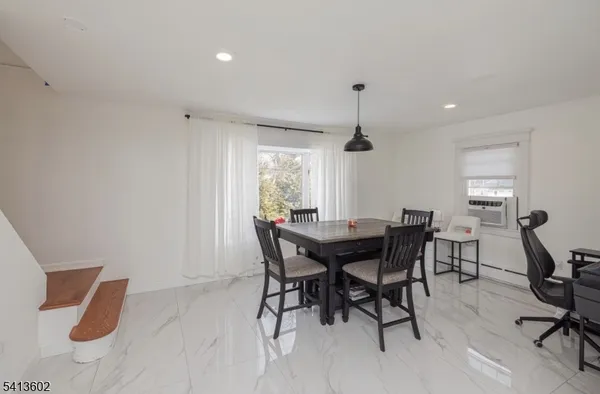 a view of a dining room with furniture and window