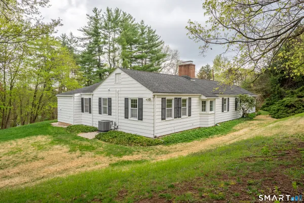 a front view of a house with a yard and porch