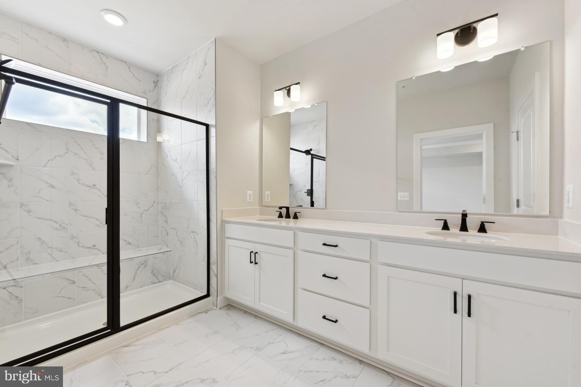 20783 Rumbullion Drive Sterling, VA 20166 - Photo 15 of 20 a bathroom with a double vanity sink mirror and shower