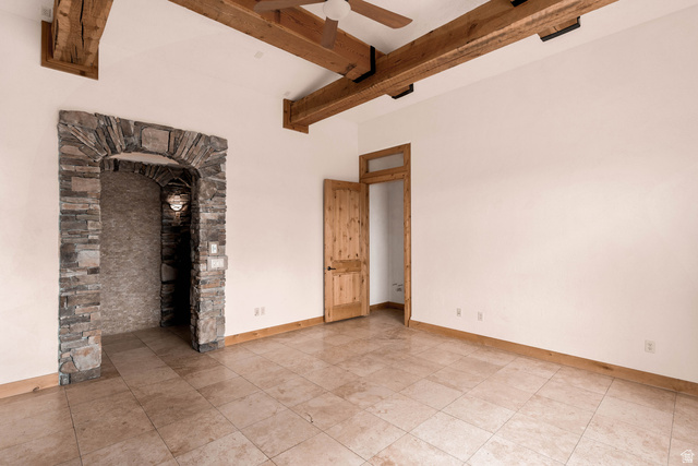 2464 East Granite Way St. George, UT 84790 - Photo 75 of 106 Unfurnished living room featuring a ceiling fan and beamed ceiling