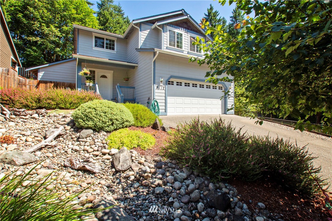 a view of a house with a yard and tree s