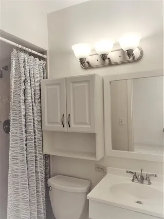 a bathroom with a sink a toilet and mirror