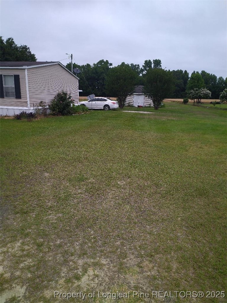 887 Stephens Road Lumberton, NC 28358 - Photo 7 of 9 a view of a lake with a yard
