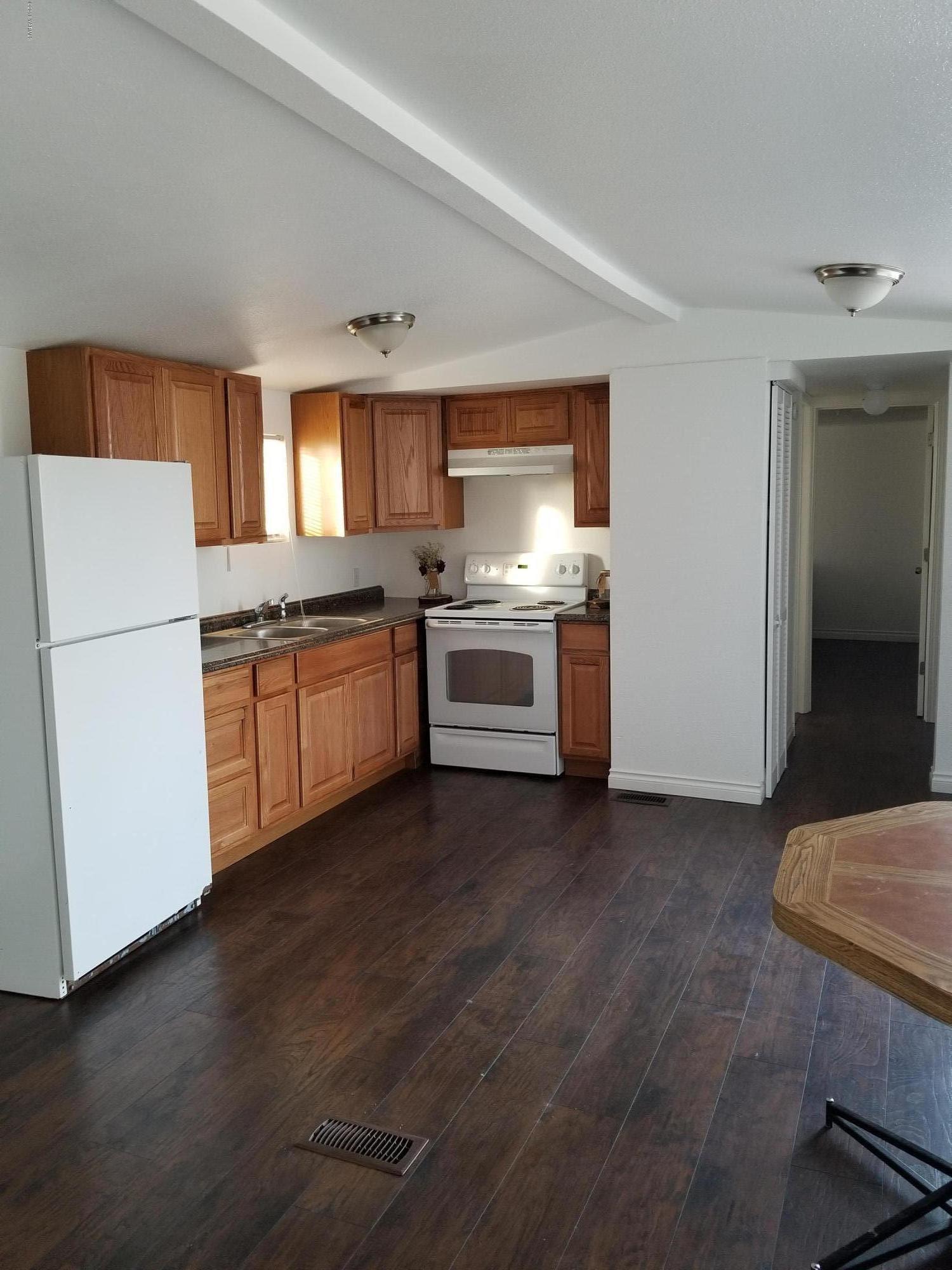 2802 Beaudry Road, Unit 58B Yakima, WA 98901 - Photo 3 of 11 a kitchen with stainless steel appliances granite countertop a stove and a refrigerator