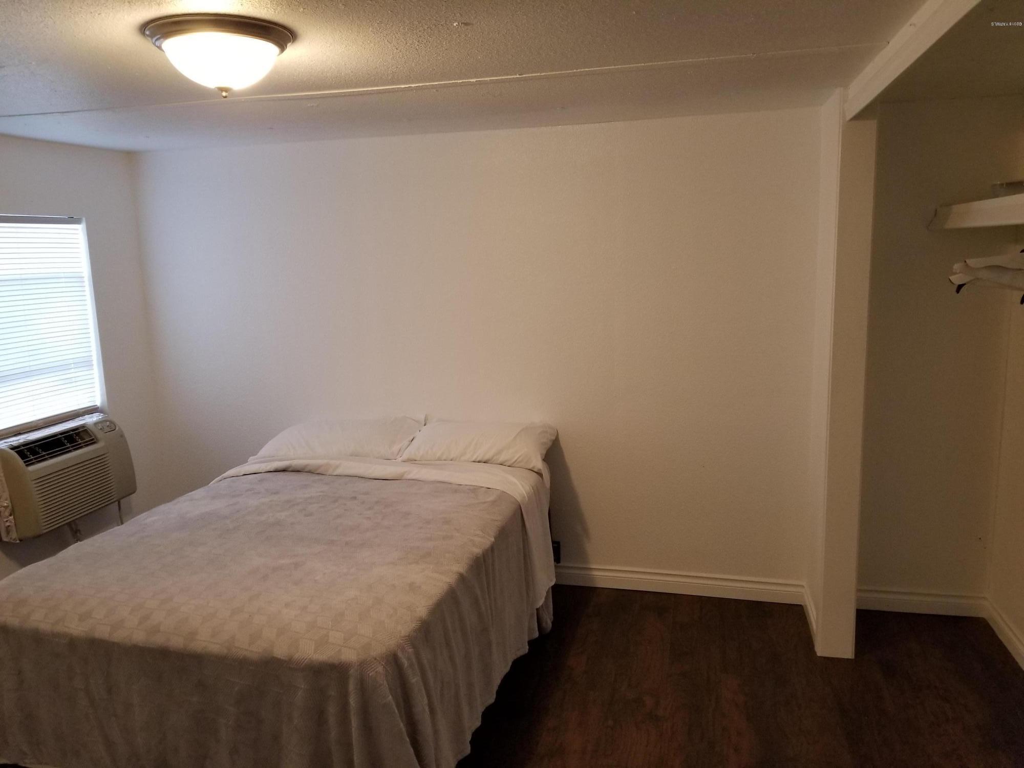 2802 Beaudry Road, Unit 58B Yakima, WA 98901 - Photo 5 of 11 a bed sitting in a bedroom next to a window