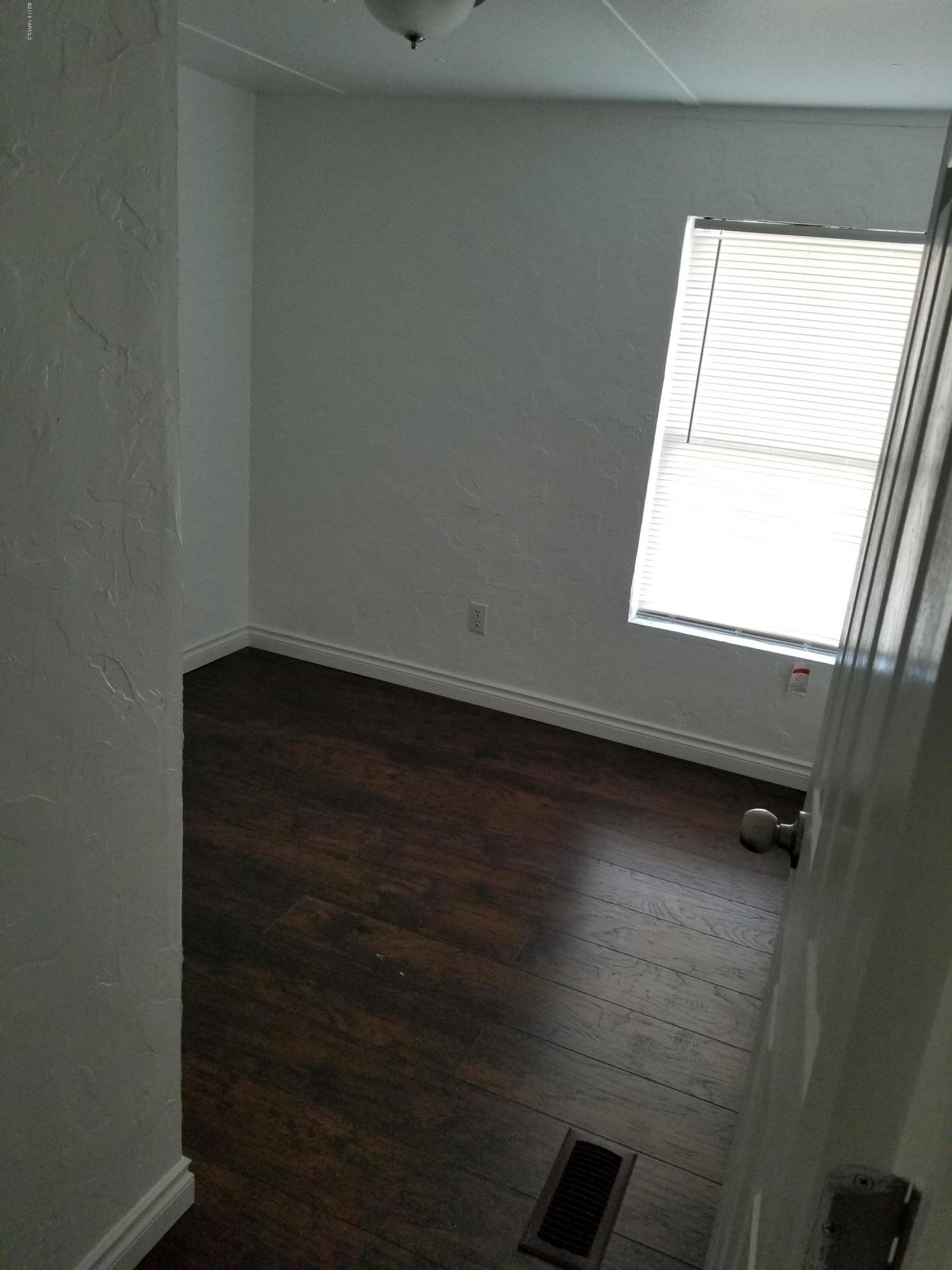 2802 Beaudry Road, Unit 58B Yakima, WA 98901 - Photo 7 of 11 an empty room with wooden floor and windows