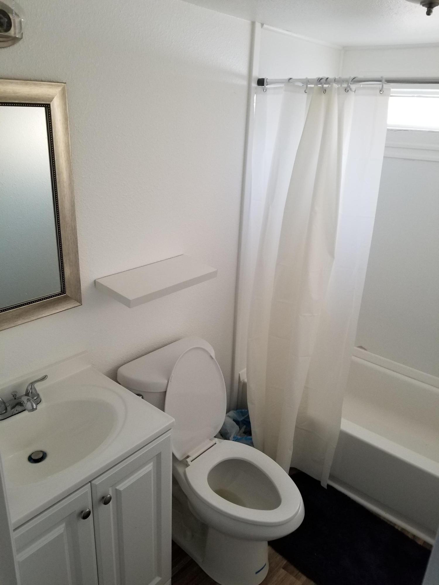 2802 Beaudry Road, Unit 58B Yakima, WA 98901 - Photo 9 of 11 a white toilet sitting next to a bathroom sink
