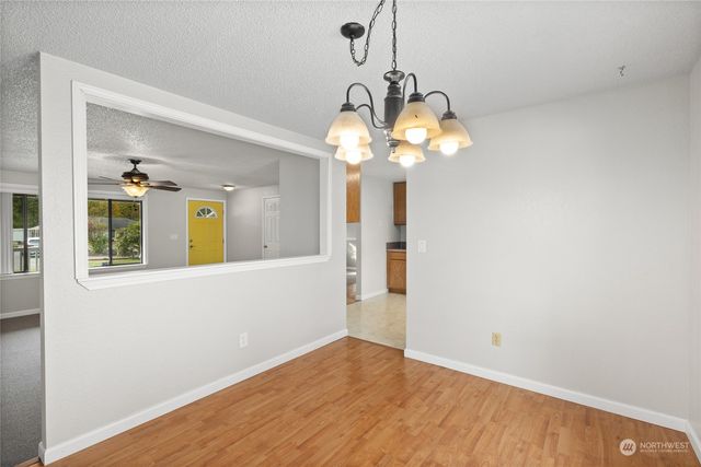 a view of a room with wooden floor and chandelier