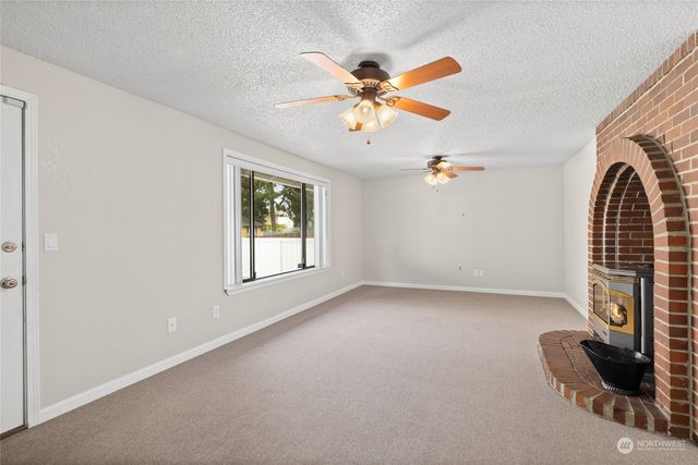 a view of a livingroom with furniture and a ceiling fan