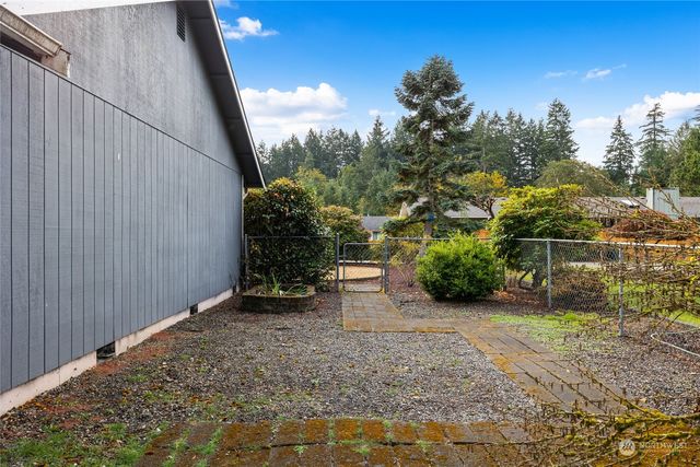 a wooden house with a trees in the background