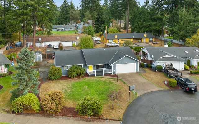 an aerial view of a house with a garden and pool