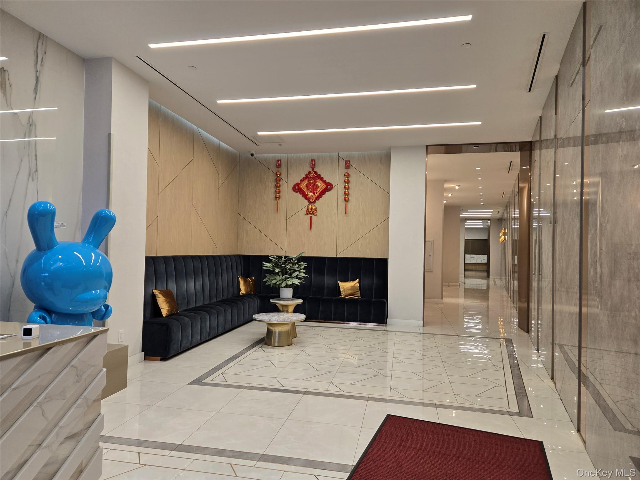 136-18 Maple Avenue, Unit 5E Queens, NY 11355 - Photo 2 of 11 a living room with furniture and a rug