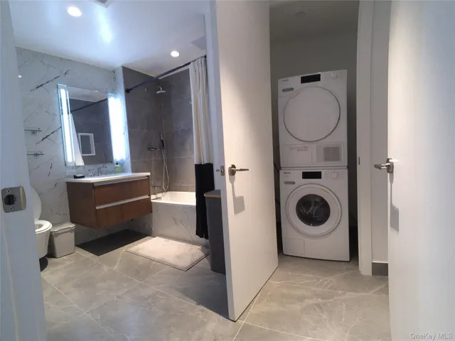 a bathroom with a toilet a sink and a mirror